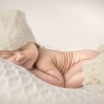 Sovende nyfødt med en hat på